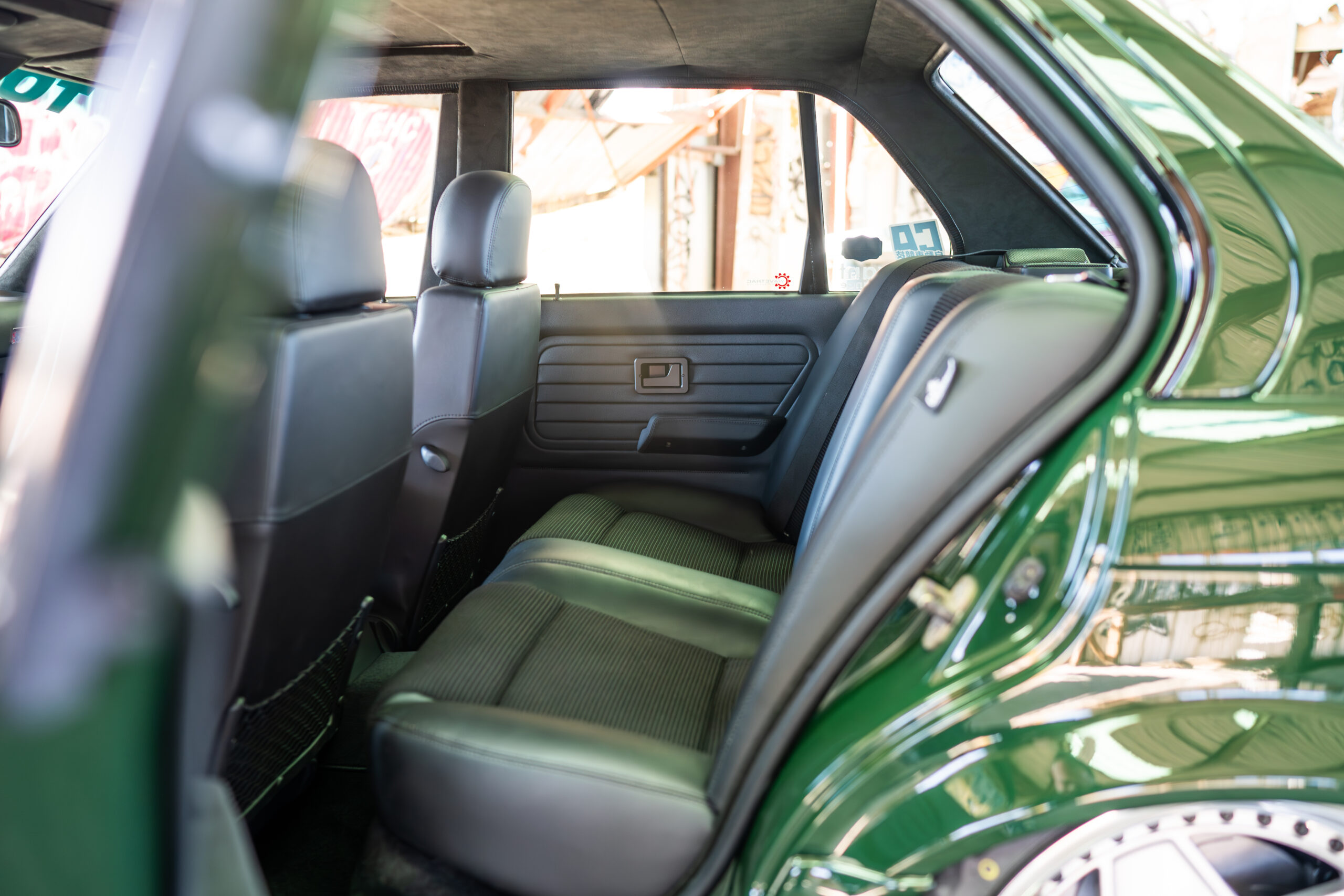 The Greenmaxhine BMW E30 Sedan by CAtuned
