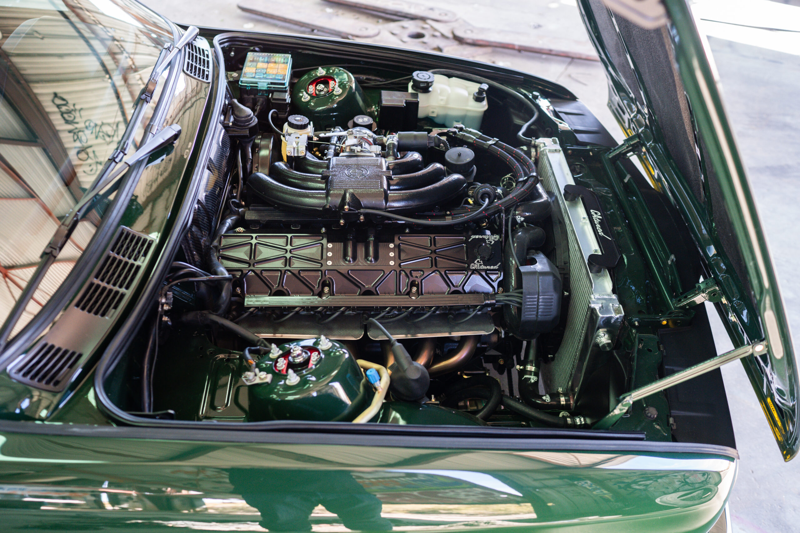 The Greenmaxhine BMW E30 Sedan by CAtuned